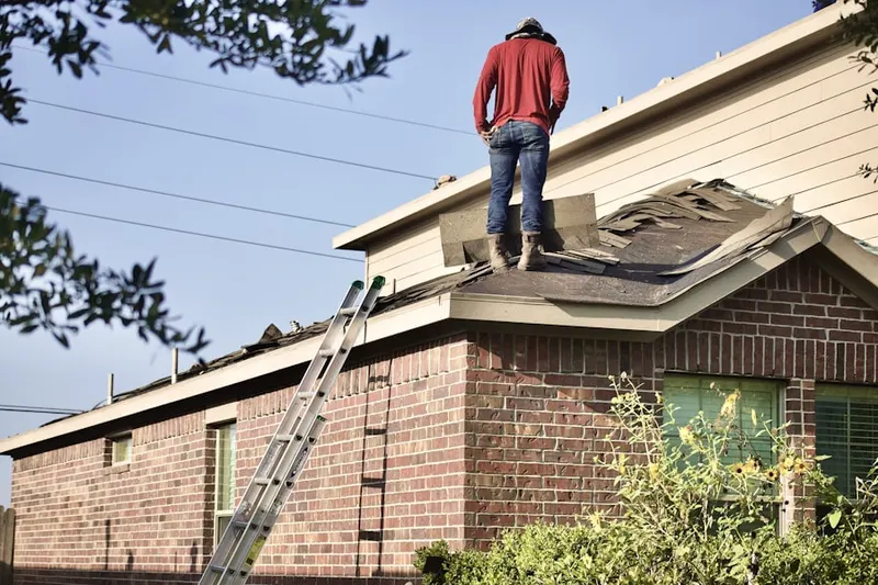 Professional roofer working on a residential roof in Lynnview